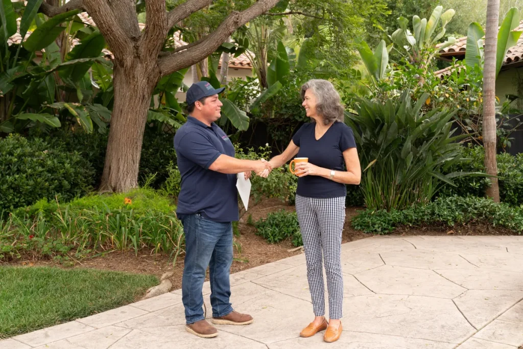 shaking hands with a tree service customer